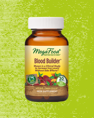 megafood vitamin bottle over green background