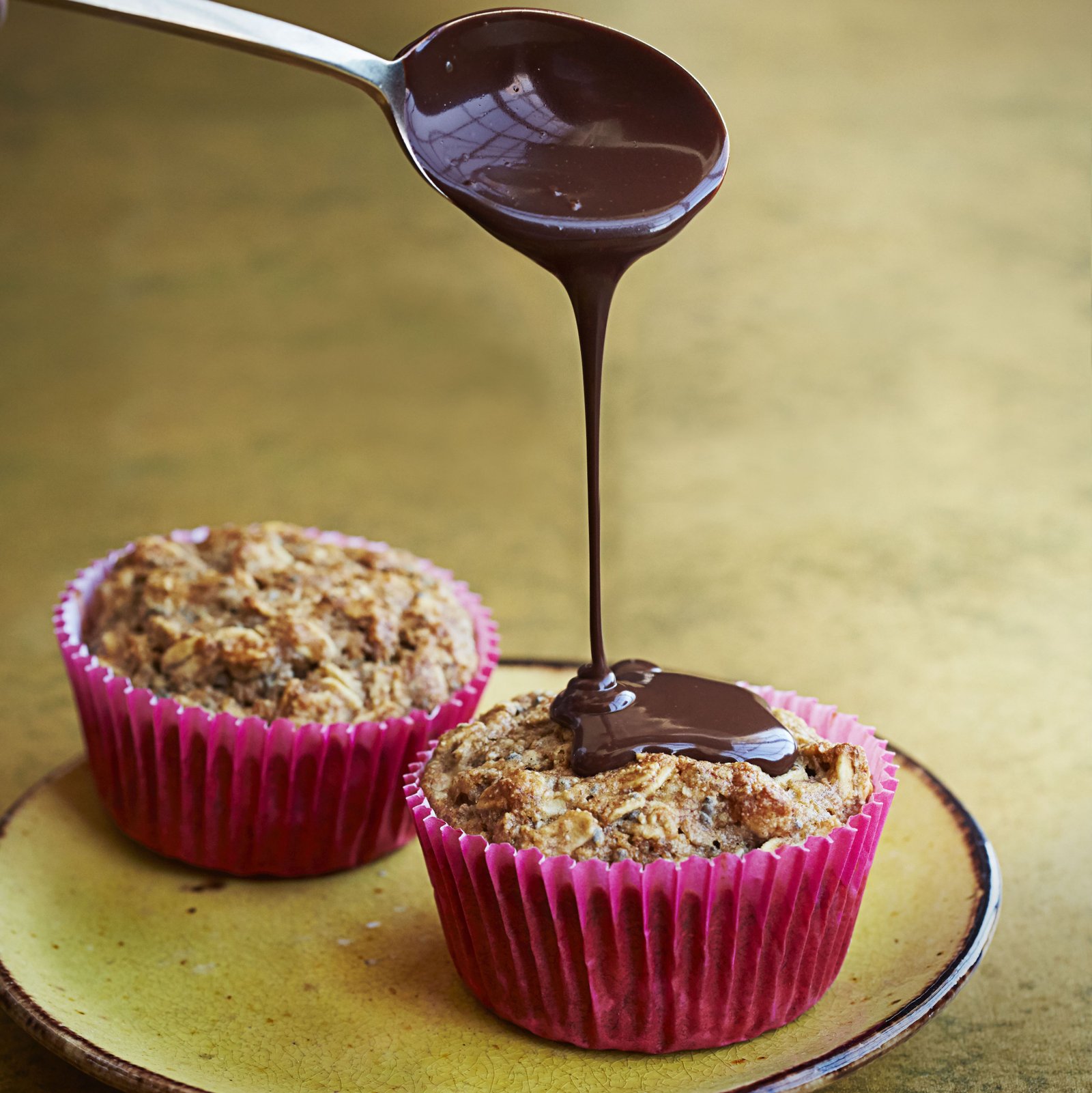 spiced banana chocolate muffins on a yellow plate