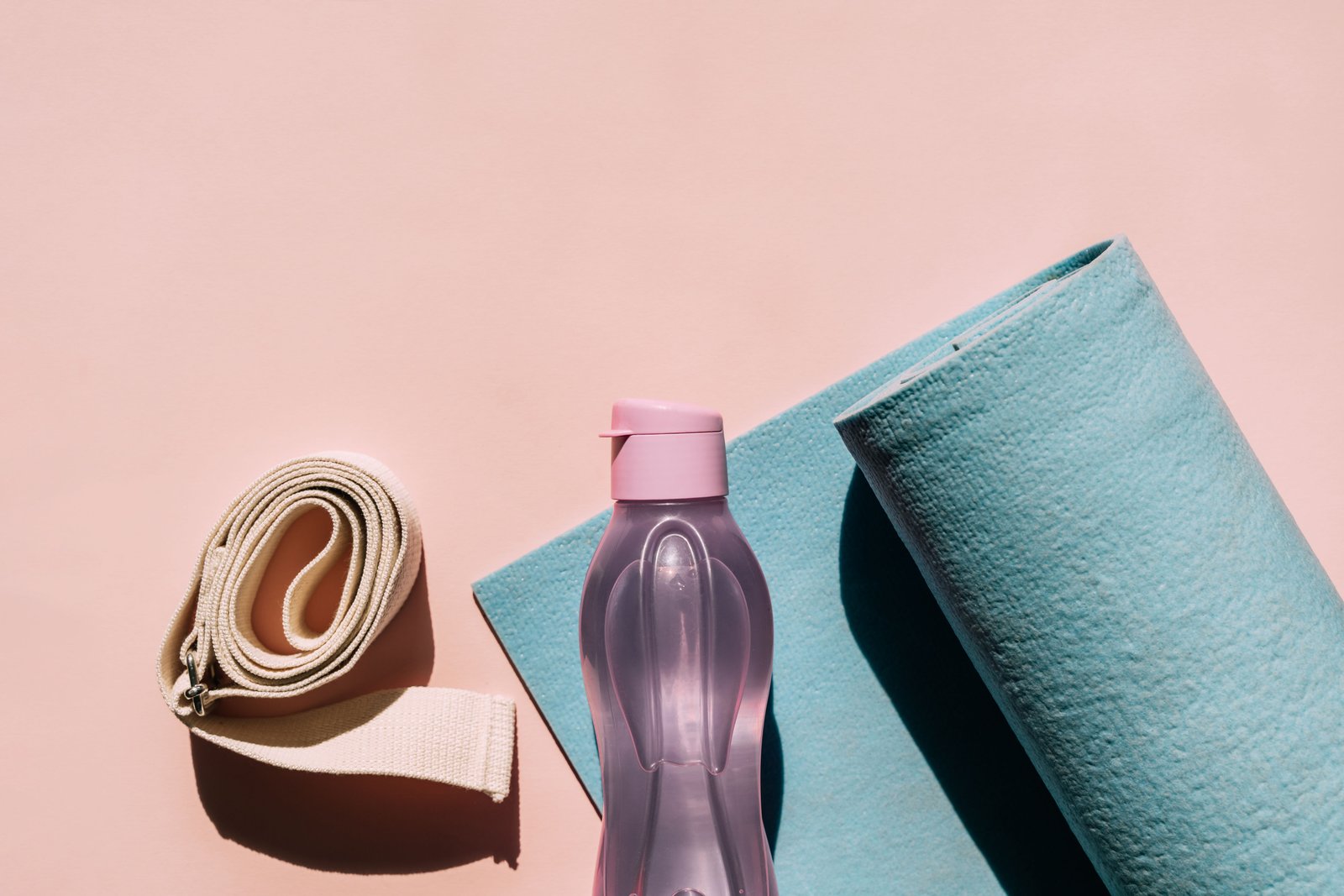 yoga props exercise mat, bottle of water and belt