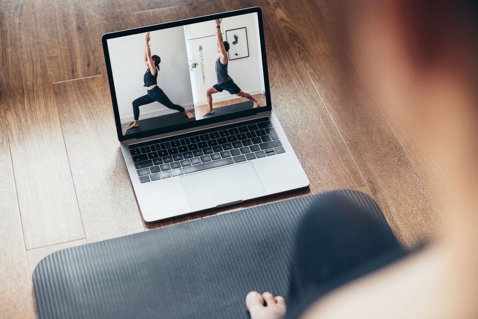 Young Woman Practising Yoga Workout With A Video Lesson On Laptop. young woman practising yoga workout with a video lesson on laptop